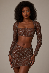 Tisiny- Minifalda transparente con cintura en V adornada en color cacao intenso.